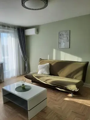 a living room with a couch and a coffee table at Visinskio apartamentai in Šiauliai