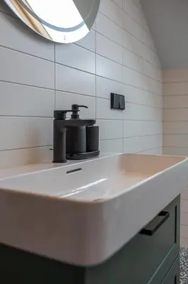 a bathroom sink with a black faucet on it at M8 Exclusive Studio Apartment in Kaunas