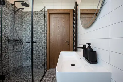 a bathroom with a shower and a sink and a shower at M8 Exclusive Studio Apartment in Kaunas