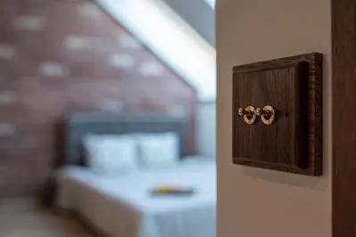 a wooden switch with two handles on a wall at M8 Exclusive Studio Apartment in Kaunas