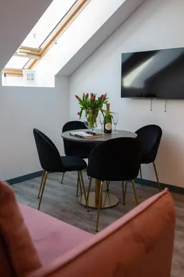 a dining room with a table and chairs at M8 Stylish One-Bedroom Apartment in Kaunas