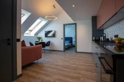 a kitchen and living room with a view of a room at M8 Stylish One-Bedroom Apartment in Kaunas