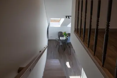 a staircase with a table and chairs in a house at M8 Modern Two-Floor Apartment in Kaunas