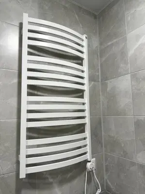 a white towel rack in a bathroom at OZO Life Apartment in Vilnius