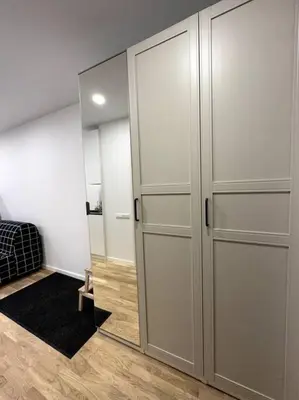 a room with two closets and a mirror at OZO Life Apartment in Vilnius