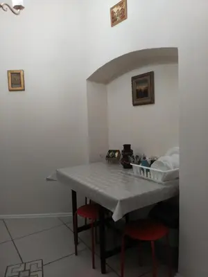 a table with two red stools in a room at Dora Apartment Užupis in Vilnius