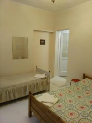 a bedroom with two beds and a mirror at Dora Apartment Užupis in Vilnius