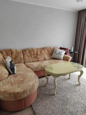 a living room with a couch and a coffee table at Apartamentai G&G in Jurbarkas