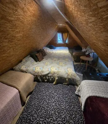 a bedroom with two beds in a attic at DAGNA summer house in Šunupis