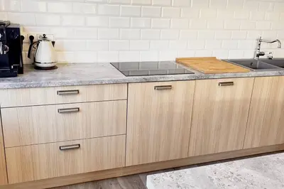 a kitchen with a sink and a counter top at Amazing Riverside home/Kayaks&Sauna/Grill&Garden in Pabradė