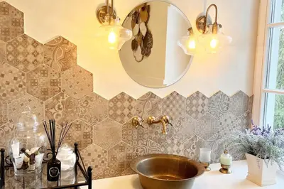 a bathroom with a copper sink and a mirror at Amazing Riverside home/Kayaks&Sauna/Grill&Garden in Pabradė