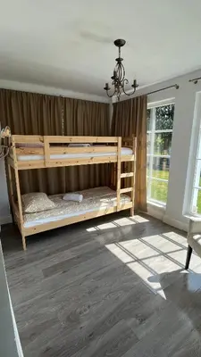 a bedroom with two bunk beds in a room at Amazing Riverside home/Kayaks&Sauna/Grill&Garden in Pabradė