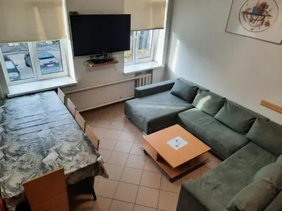 a living room with a couch and a tv at Spacy apartment in Kaunas center in Kaunas