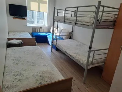 a room with two bunk beds and a television at Spacy apartment in Kaunas center in Kaunas