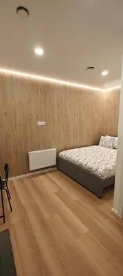 a bedroom with a bed and a wooden floor at 14 New Airport Apartment in Vilnius