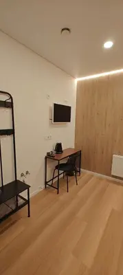 a room with a desk and a table in a room at 14 New Airport Apartment in Vilnius