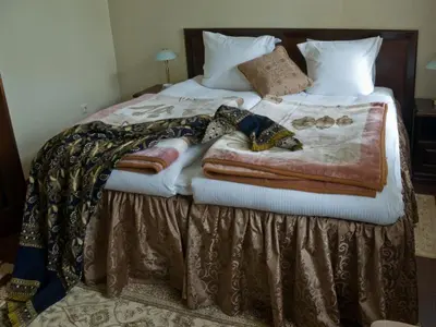 a bed with a blanket and pillows on it at Bellavilla in Vilnius