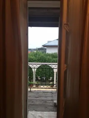 an open door with a view of a balcony at Bellavilla in Vilnius