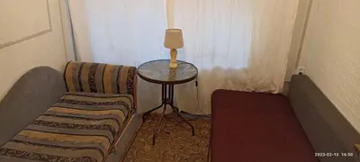 a corner of a room with a table and a chair at Kambario nuoma namelyje in Kaunas