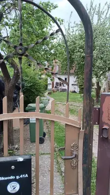 a wooden fence with a gate in a yard at Kambario nuoma namelyje in Kaunas
