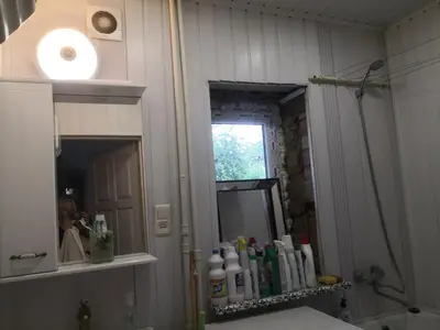a bathroom with a shower and a sink and a mirror at Kambario nuoma namelyje in Kaunas