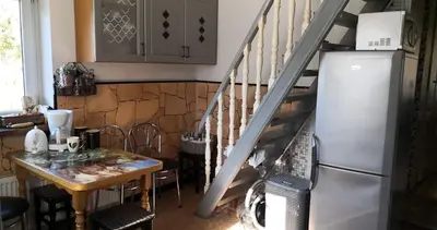 a kitchen with a table and a refrigerator at Kambario nuoma namelyje in Kaunas