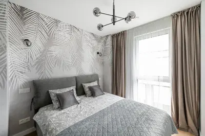 a bedroom with a bed and a large window at Žalia kopa Metropolis Vilnius in Vilnius