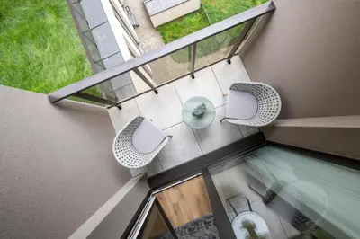 an overhead view of a balcony with a table and chairs at Žalia kopa Metropolis Vilnius in Vilnius