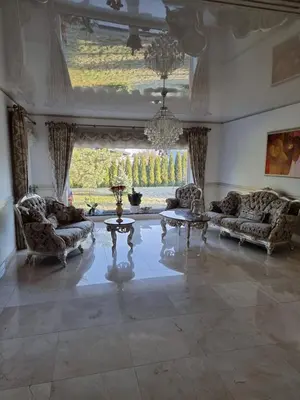 a large living room with couches and a large window at Druskininkai Algida in Druskininkai