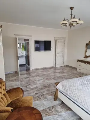 a bedroom with a bed and a tv on a wall at Druskininkai Algida in Druskininkai