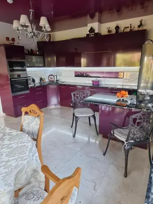 a kitchen with purple walls and a table and chairs at Druskininkai Algida in Druskininkai