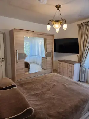 a bedroom with a large bed and a large window at Druskininkai Algida in Druskininkai