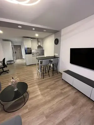 a living room with a flat screen tv and a table at Lovely Flat with Great Central Location Vilnius in Vilnius