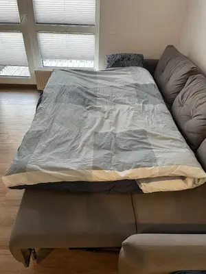 a bed sitting on top of a couch at Lovely Flat with Great Central Location Vilnius in Vilnius