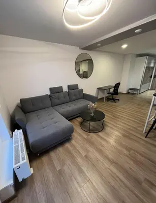 a living room with a couch and a table at Lovely Flat with Great Central Location Vilnius in Vilnius