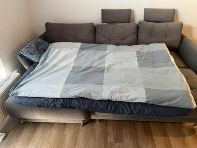 a large bed sitting on top of a couch at Lovely Flat with Great Central Location Vilnius in Vilnius