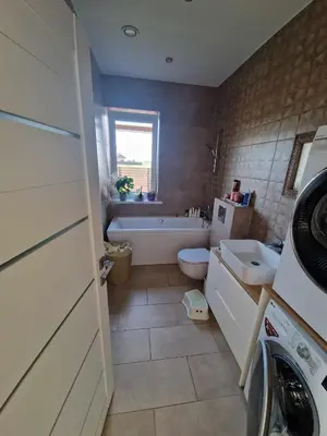 a bathroom with a tub and a toilet and a sink at Entire House for a company of Friends in Kaunas