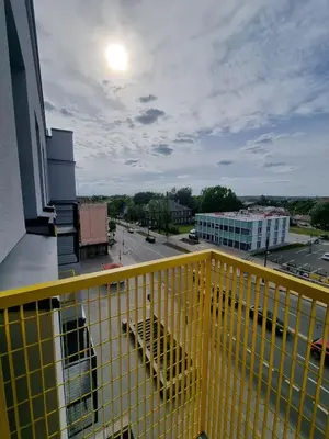 a yellow railing on a balcony of a building at Cozy Loft in Kaunas