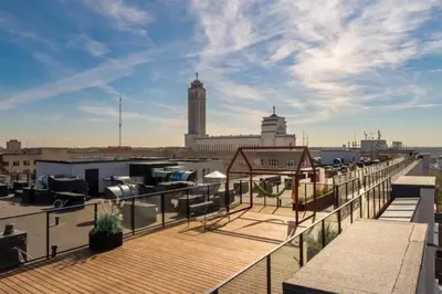 a balcony with a view of a city with a building at Cozy Loft in Kaunas