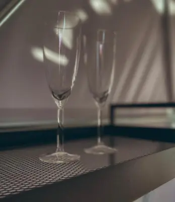 three wine glasses sitting on a table at Greenery Kupolai in Kalveliai