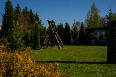a park with a swing set in the grass at Greenery Kupolai in Kalveliai