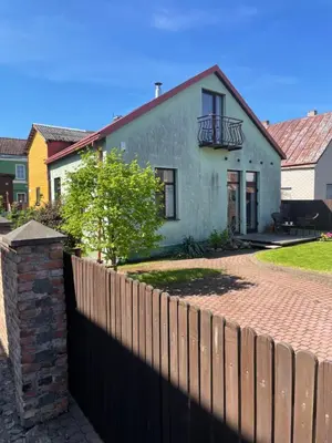 a white house with a fence in front of it at Namas senamiestyje in Kėdainiai