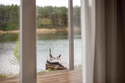 a view from a window of a boat on a lake at Pineplace twins NIDA in Žaugėdai