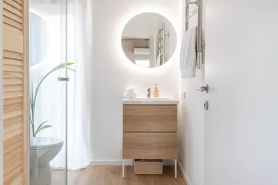 a bathroom with a sink and a mirror at Pineplace twins NIDA in Žaugėdai