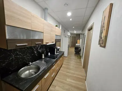 a large bathroom with a sink and a hallway at Kauno apartamentai in Kaunas
