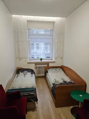 a bedroom with two beds and a window at Kauno apartamentai in Kaunas