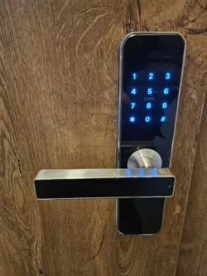 a cell phone sticking out of a door handle at Kauno apartamentai su balkonu in Kaunas