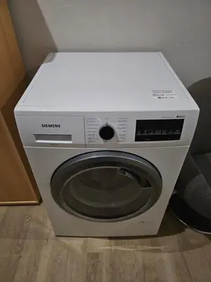 a washing machine with a white box on top of it at Kauno apartamentai su balkonu in Kaunas