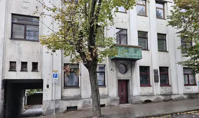 a building with a tree in front of it at Kauno apartamentai su balkonu in Kaunas