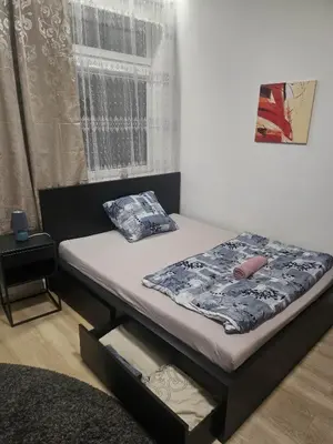 a small bed in a room with a window at Kauno apartamentai su balkonu in Kaunas